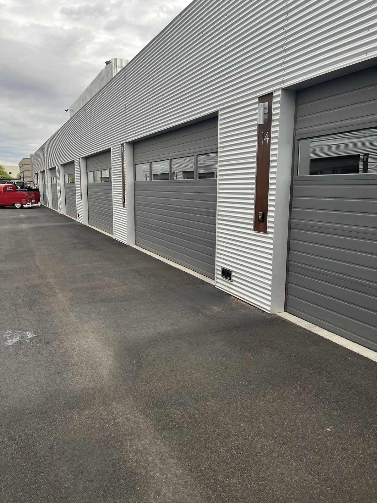 Row of industrial units with freshly sprayed two-tone grey corrugated cladding
